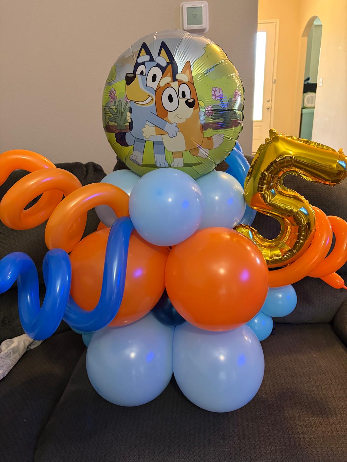Blue and orange birthday balloon stack with a number five