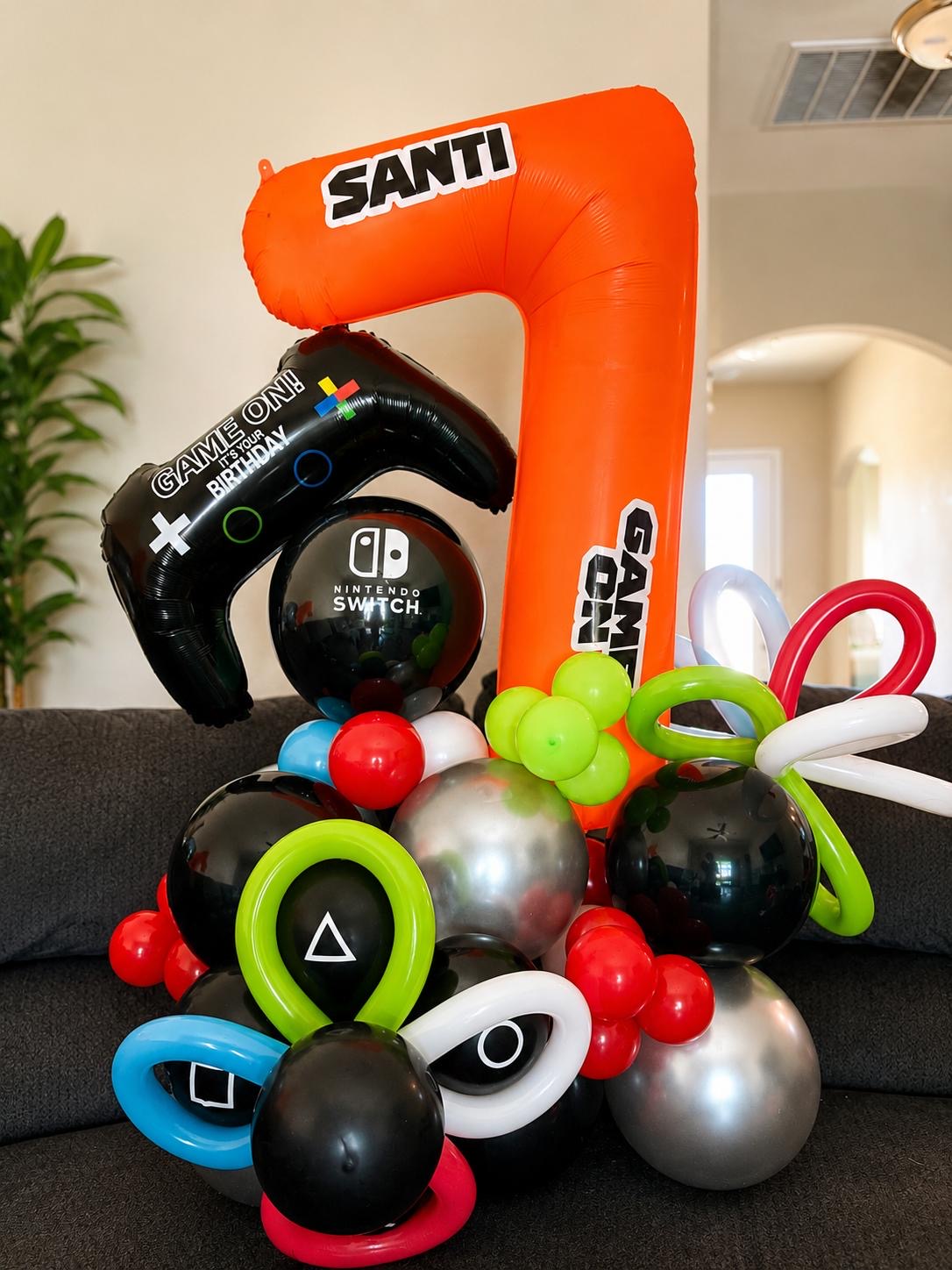 Video game themed birthday balloon stack with a number seven
