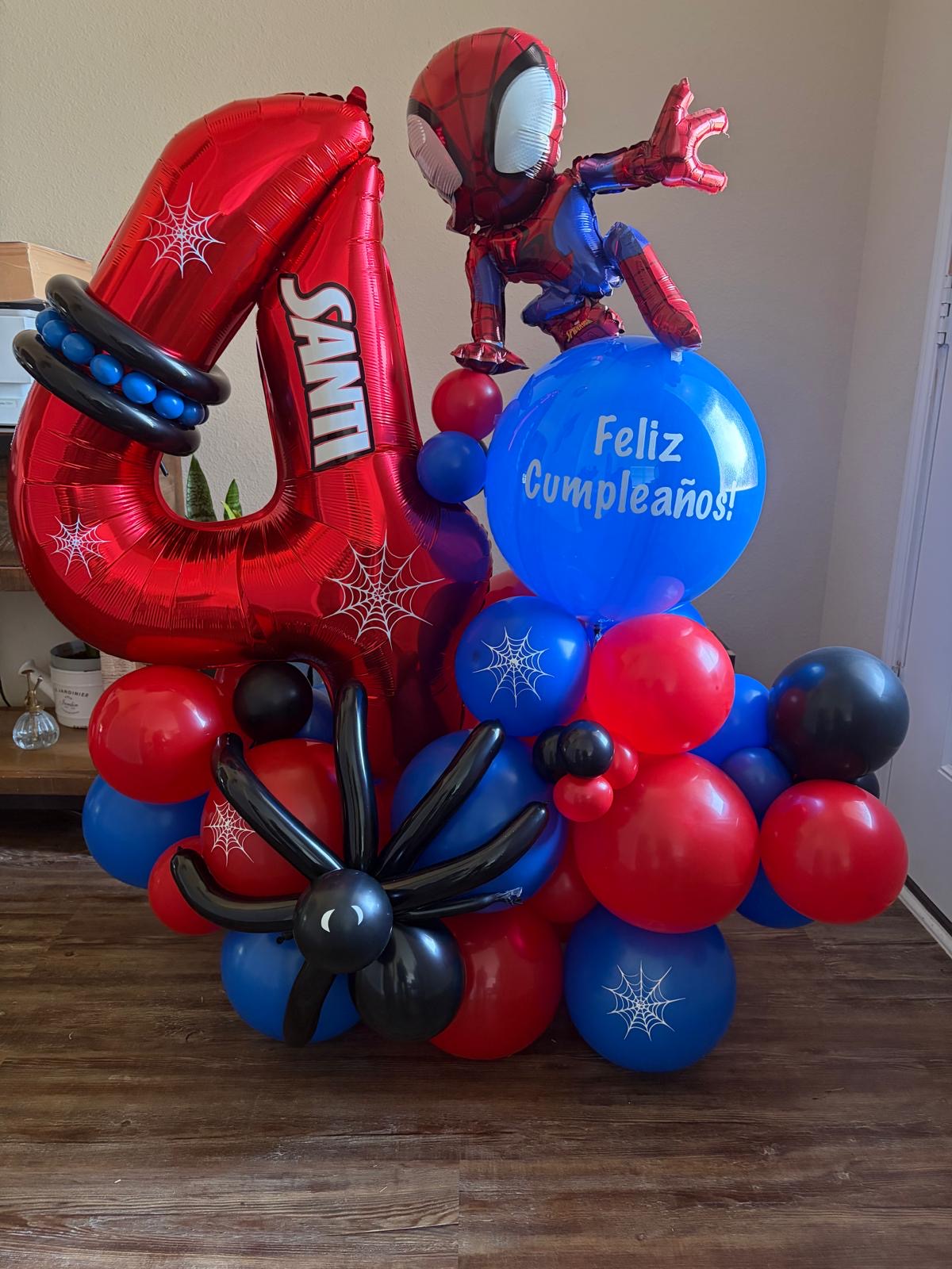 Red and blue superhero birthday balloon stack with a number four