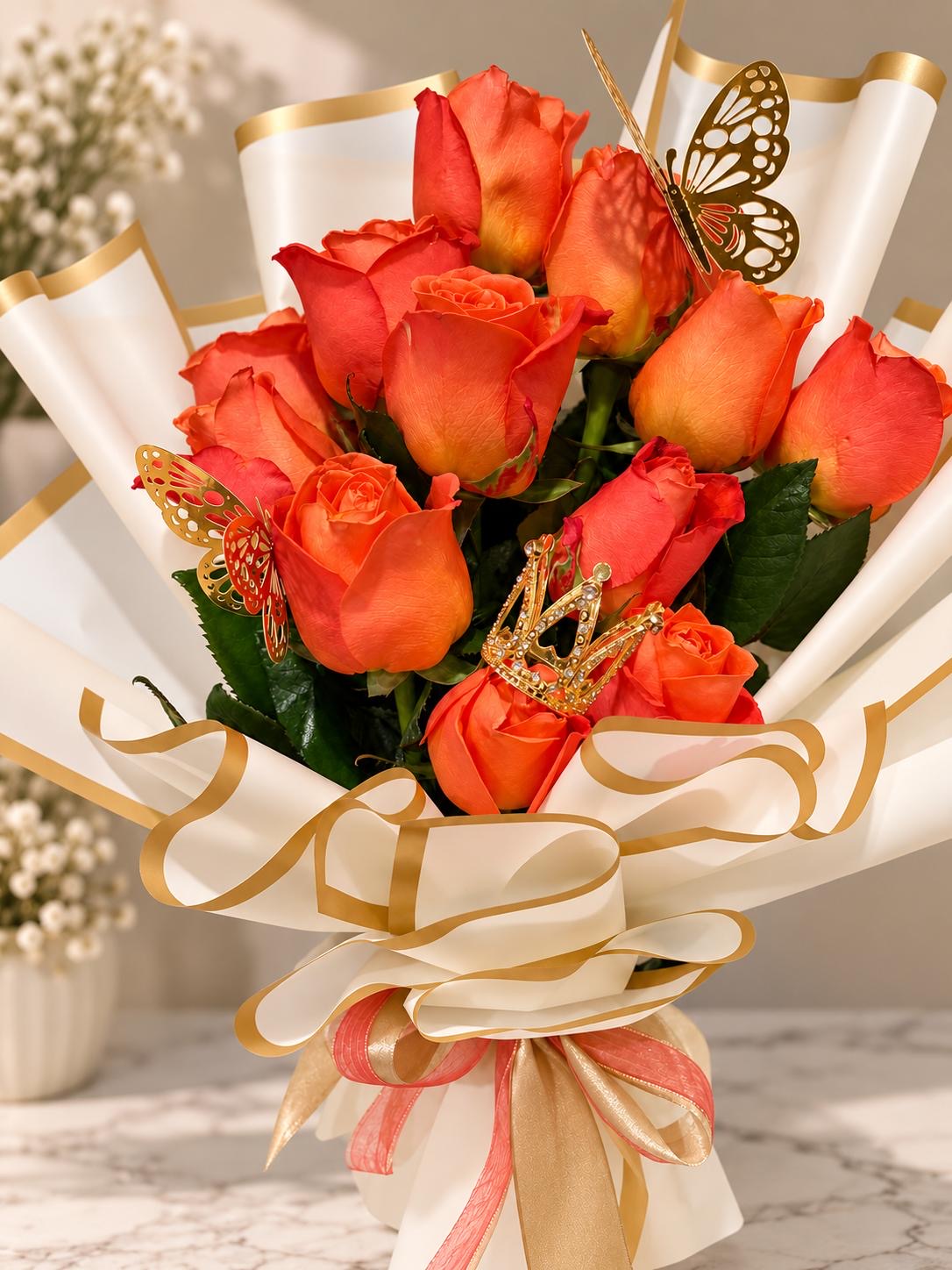 Orange rose bouquet in cream and gold wrapping with a butterfly accent