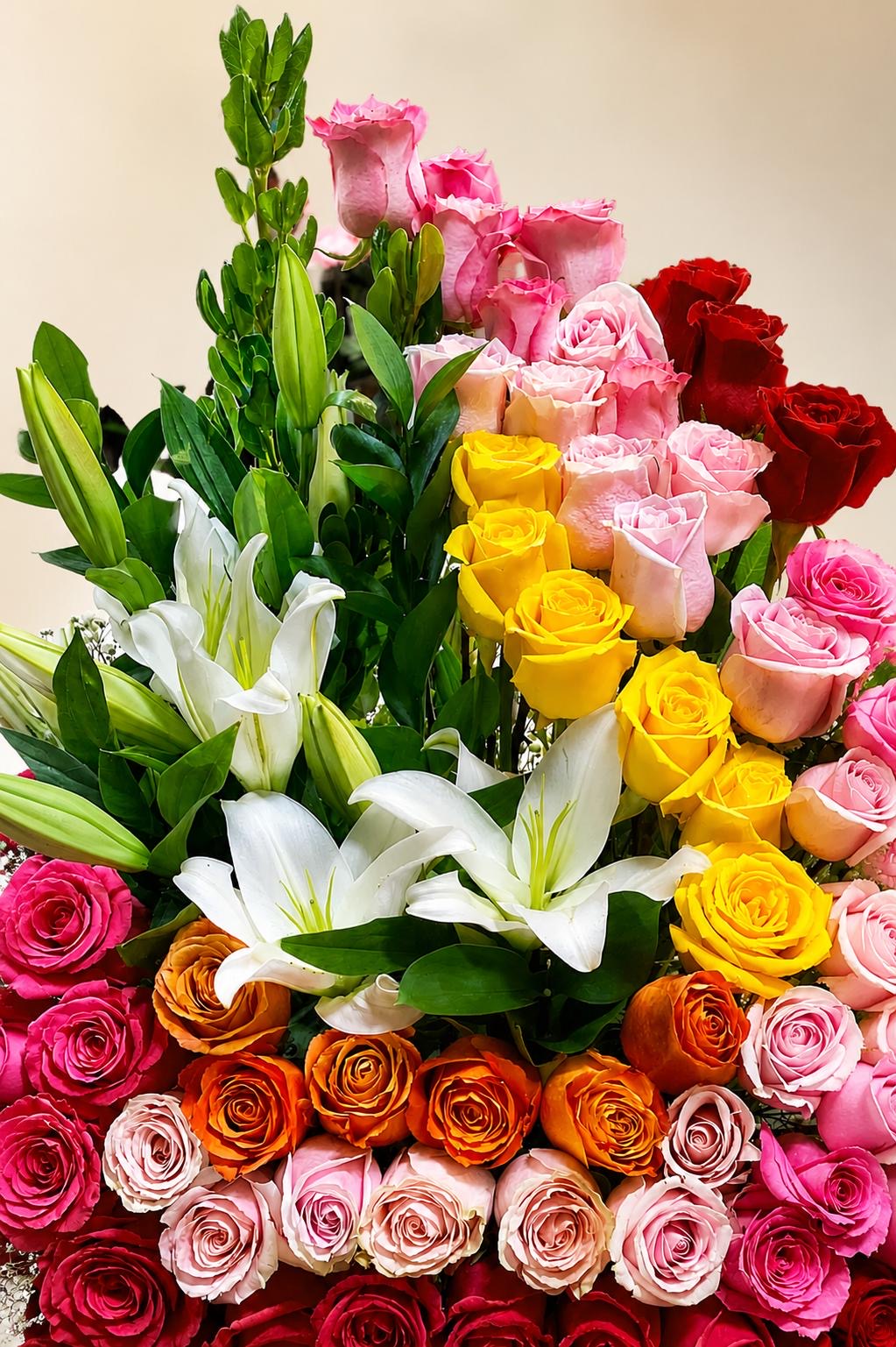 Tall arrangement of multicolored roses and white lilies