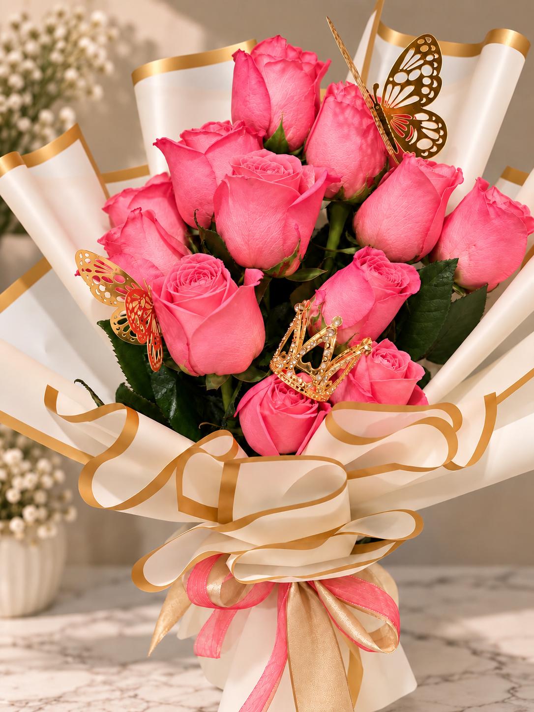 Pink rose bouquet in cream and gold wrap with gold butterflies and a crown